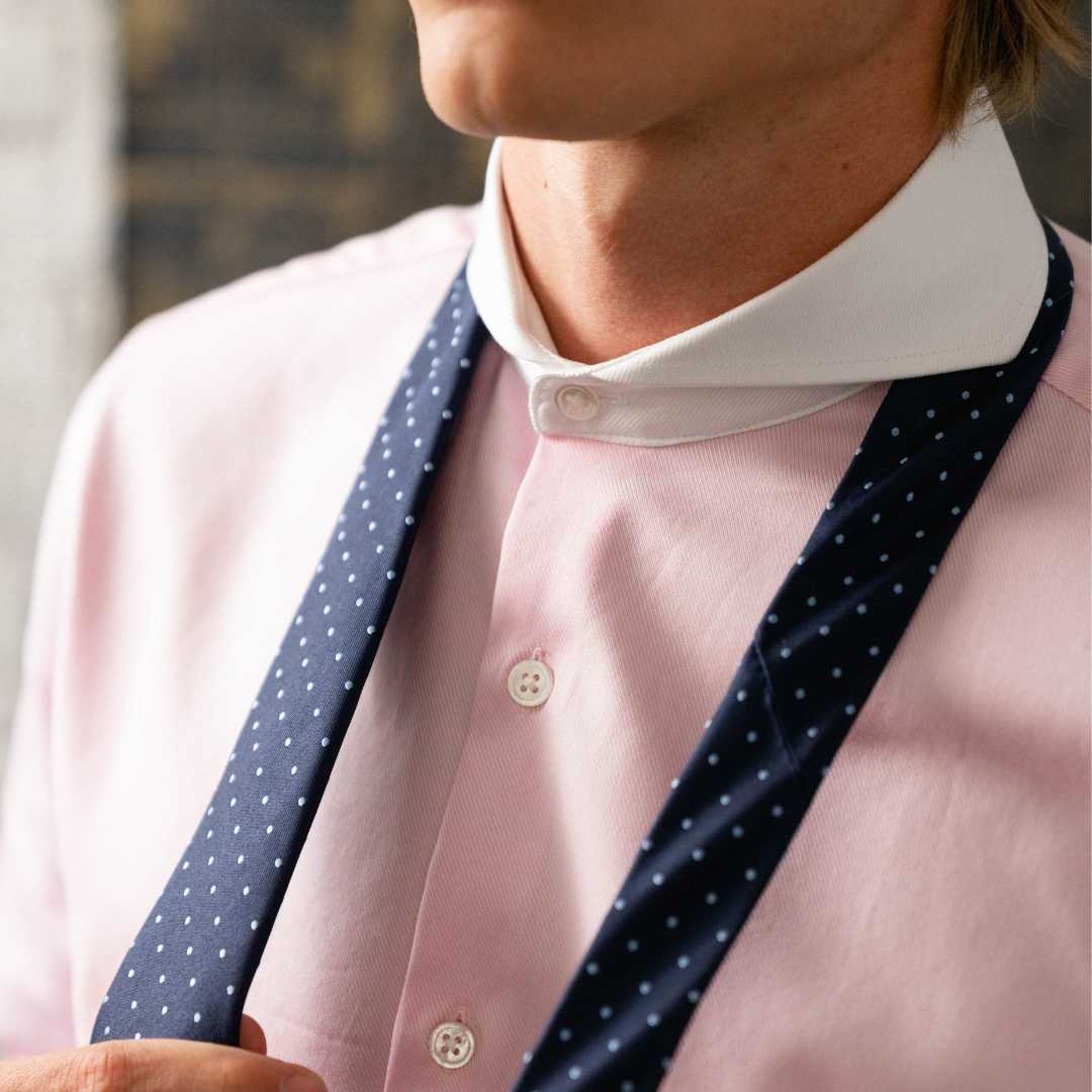 Close up of prink contrast collar dress shirt and tie