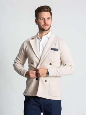 Model wearing beige double breasted knitted cashmere jacket on model 