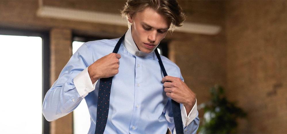 Model wearing extreme cutaway white shirt and tie 