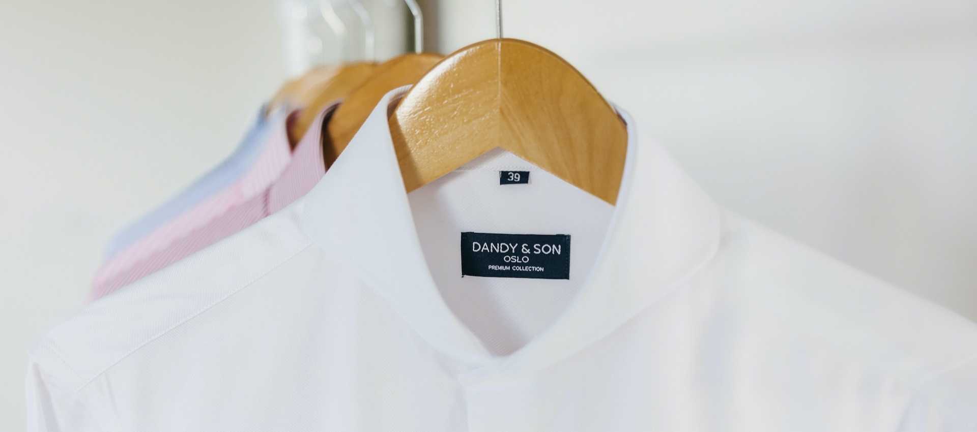 Discounted and Sale Shirts for Men from Dandy & Son. Image a White Extreme Cutaway Collar Shirts from Dandy & Son on a hanger.