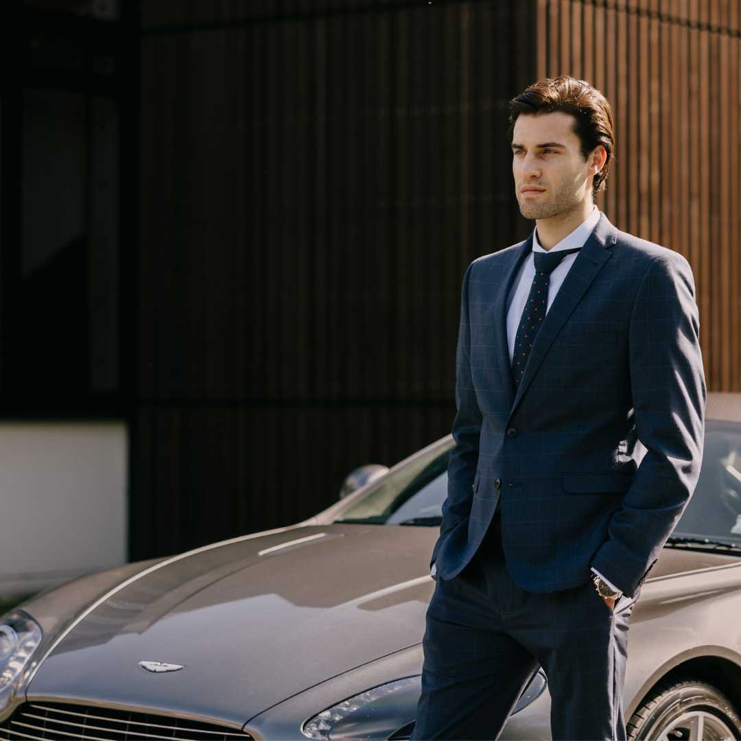 Model wearing navy suit with an extreme cutaway collar dress shirt