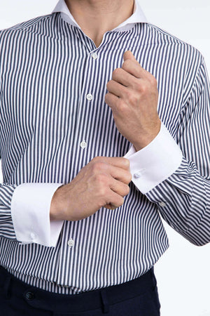 Close up on model wearing extreme cutaway collar shirt in navy stripe